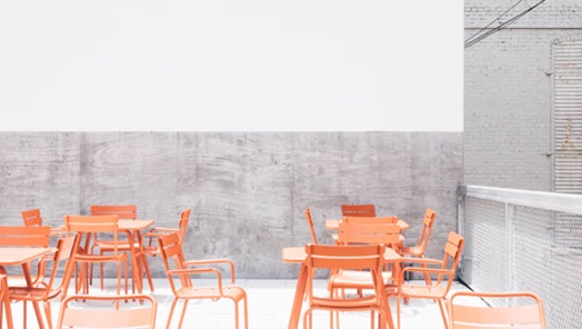 Restaurant dining area with peach-coloured, patio-style furniture