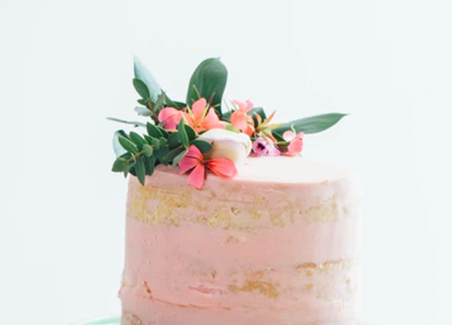 Pink cake with edible flower arrangement on top